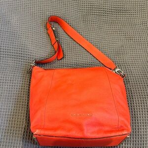 Red purse, some fading (pictured) on the leather otherwise good condition.
